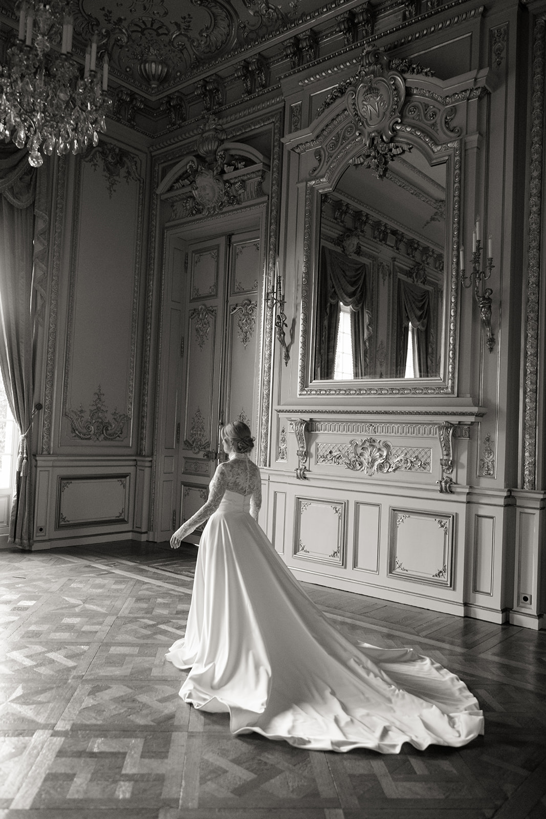 The bride walks towards the window